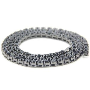 Macro detail of a 5mm black tennis chain with inset black crystals on a dark alloy base