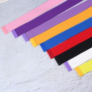 Versatile nylon canvas belts with matte buckles shown in a vibrant multi-color assortment