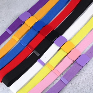 Detailed flat lay of nylon canvas belts in various vibrant colors with matching matte buckles