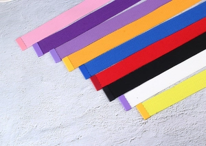 Diagonal arrangement of colorful nylon canvas belts with various vibrant texture finishes