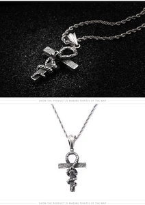 Macro view of gothic snake wrapped around ankh cross pendant with detailed metal scales
