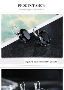 Detailed close-up showing black oval gemstone earrings with silver metallic settings