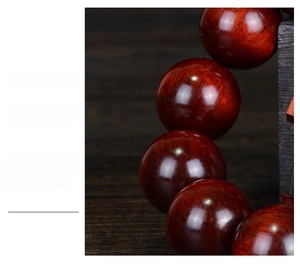 Macro shot of dark red sandalwood beads showing natural wood grain and polished texture