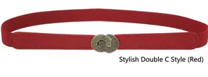 Detail of red elastic waist belt with textured gold double-C buckle on white background