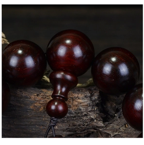 Macro shot of fine texture and oily luster on the sandalwood prayer beads detail