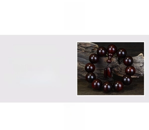 Macro shot of polished red sandalwood beads on natural wood showing dense wood grain