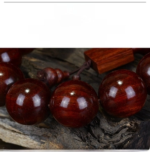 Macro detail of polished dark red wood beads showing smooth texture and natural grain