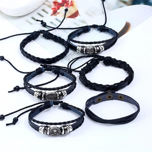 Retro black leather braided bracelet set with skull and star charms for punk rock style