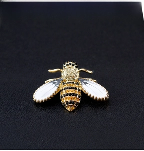 Detailed macro view of an elegant bee brooch with yellow and black crystal pave settings