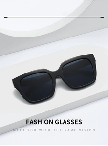 Detailed view of black oversized square sunglasses on minimalist white display stand