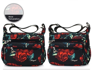 Detailed view of the multi-pocket floral nylon crossbody bag with red rose pattern