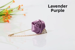 Macro view of taro purple satin rose brooch with gold leaves and delicate hanging chains