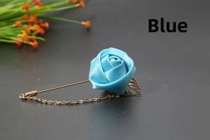 Detail of light blue satin rose brooch with gold metal leaf and safety chain design