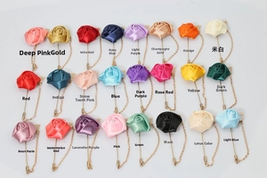 Detailed grid of 24 colorful satin rose brooches with gold chains and lapel pins