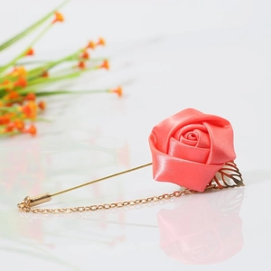 Elegant coral satin rose boutonniere with golden leaf and chain for suits and shirts