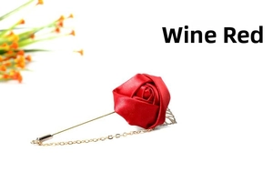 Detail of wine red satin rose brooch with gold chain and silver leaf accent