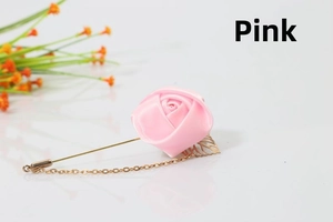 Detail of pink satin rose brooch with gold leaves and delicate hanging chain accessory
