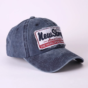 Detail of vintage washed baseball cap featuring embroidered patch and distressed stitching
