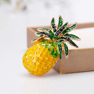 Chic pineapple brooch with golden enamel fruit and sparkling green crystals on top