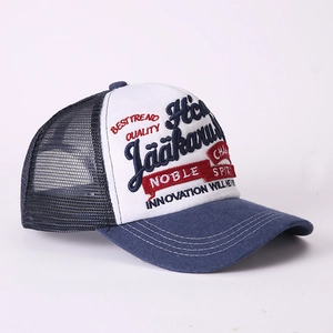 Detail of vintage trucker hat featuring 3D letter embroidery and breathable blue mesh