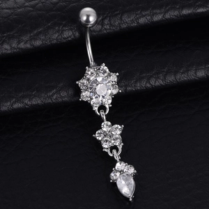 Silver flower and teardrop belly button ring with crystals on black leather background