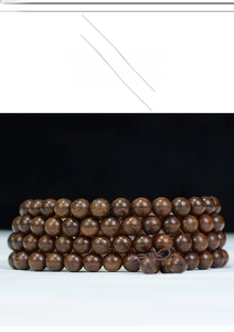 Macro detail of natural sandalwood beads showing fine wood grain and master bead