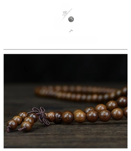 Macro detail of dark brown sandalwood beads showing rich texture and a Chinese knot