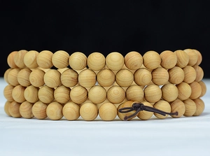 Macro view of 108 Thuja sutchuenensis wood beads showing natural grain and texture