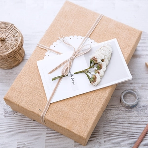 Rustic kraft gift box with gypsophila dried flowers and Especially for you card on wood
