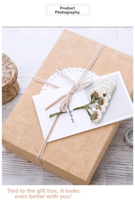 Close-up of linen gift box with white lace, dried flowers, and Especially for you card