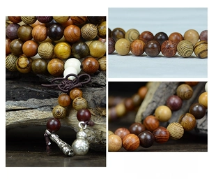 Macro shot of handcrafted 108 wood bead Buddhist bracelet with silver gourd charm