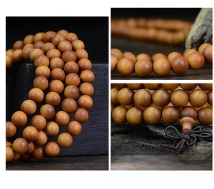 Macro shot of 108 sandalwood prayer beads showing natural wood grain and polished texture