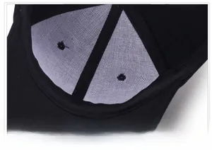 Close-up of black baseball cap interior showing white breathable mesh and reinforced seams