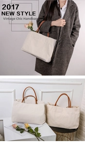 Detail of a large beige canvas tote bag featuring contrast brown leather handles and interior space