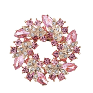 Detailed view of pink crystal flower brooch with elegant gold plating finish
