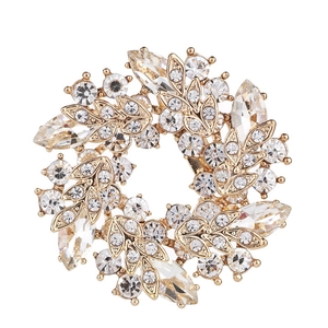 Detailed view of vintage gold bauhinia brooch with marquise crystal embellishments