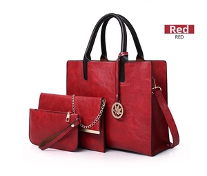 Detailed view of red 3-piece bag set with large tote, chain bag, and clutch wallet