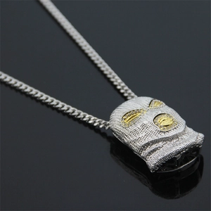 Detailed view of silver balaclava pendant with gold accents and sparkling rhinestones