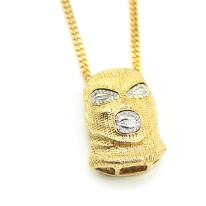 Close-up of gold hip hop balaclava pendant necklace with white rhinestone details