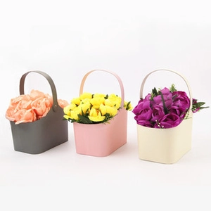 Minimalist envelope flower boxes in grey, pink, and beige with colorful roses