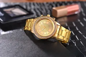 Detailed close-up of a gold luxury watch with a diamond bezel on black leather texture