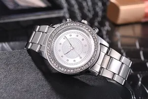 Macro shot of silver stainless steel women watch with crystal bezel on textured gift box