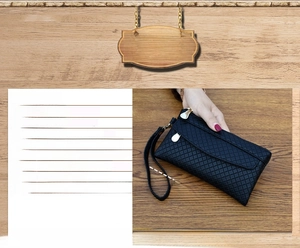 Detail view of black woven texture long wallet with triple zipper and wrist strap
