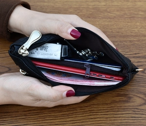 Internal view of a quilted black leather wallet showing multiple storage compartments