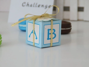 Close-up of blue alphabet chocolate boxes with golden ribbons and ABC letter designs