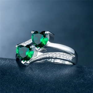 Elegant silver-plated ring featuring double heart-shaped green zircons and pavé accents