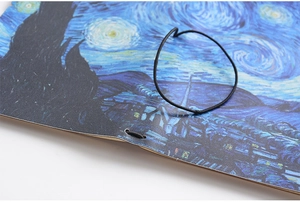 Detailed close-up of Van Gogh Starry Night notebook with black elastic closure band