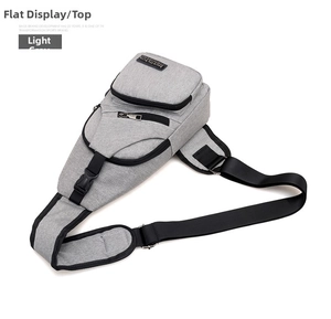 Detail of light grey nylon chest bag featuring durable zippers and adjustable strap