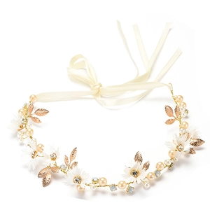 Detail view of gold floral bridal headband with white crystals, pearls and ribbon ties