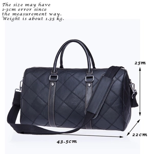 Classic black leather travel bag with diamond quilted pattern and adjustable strap